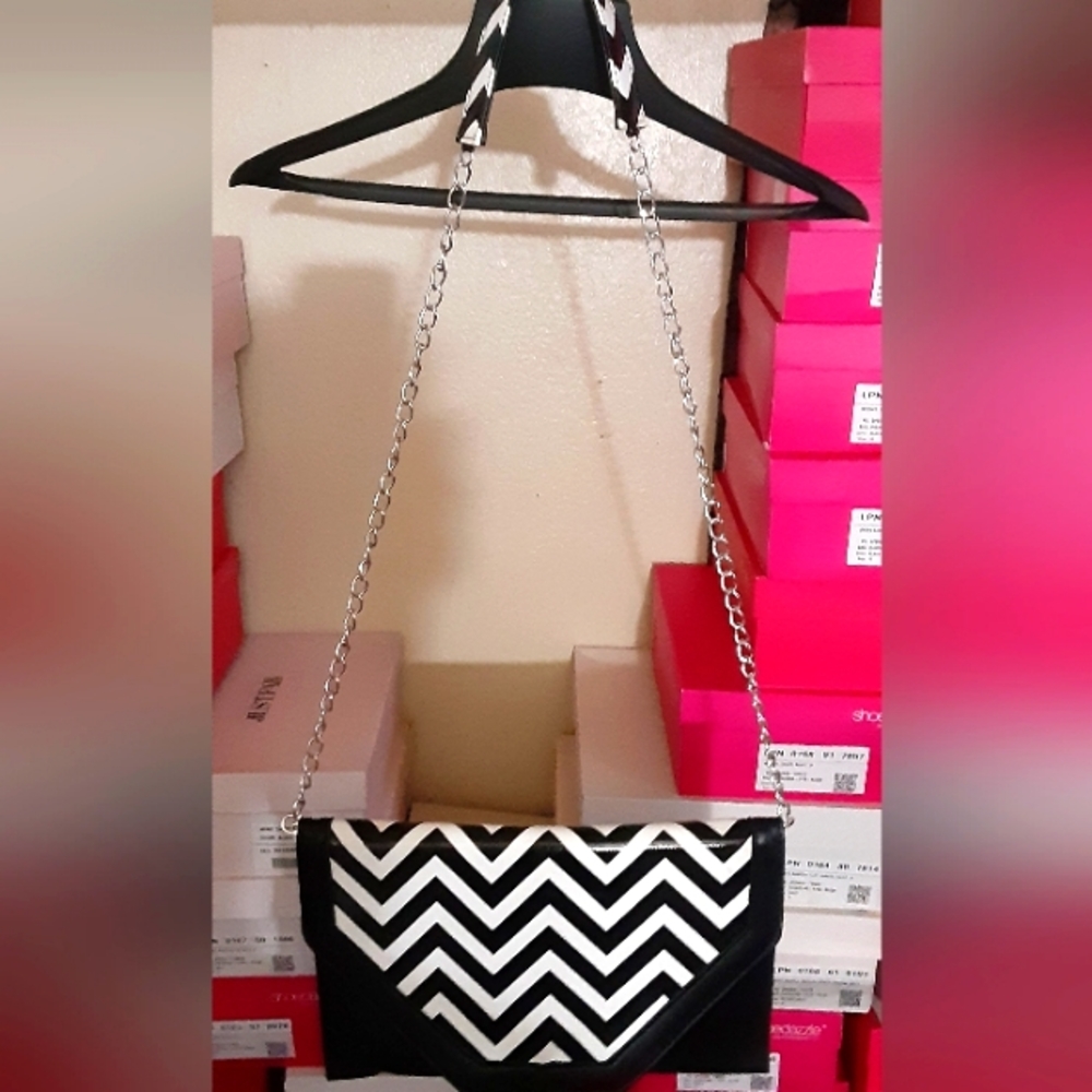 Medium/large size zigzag pattern clutch with button flap over chain strap
